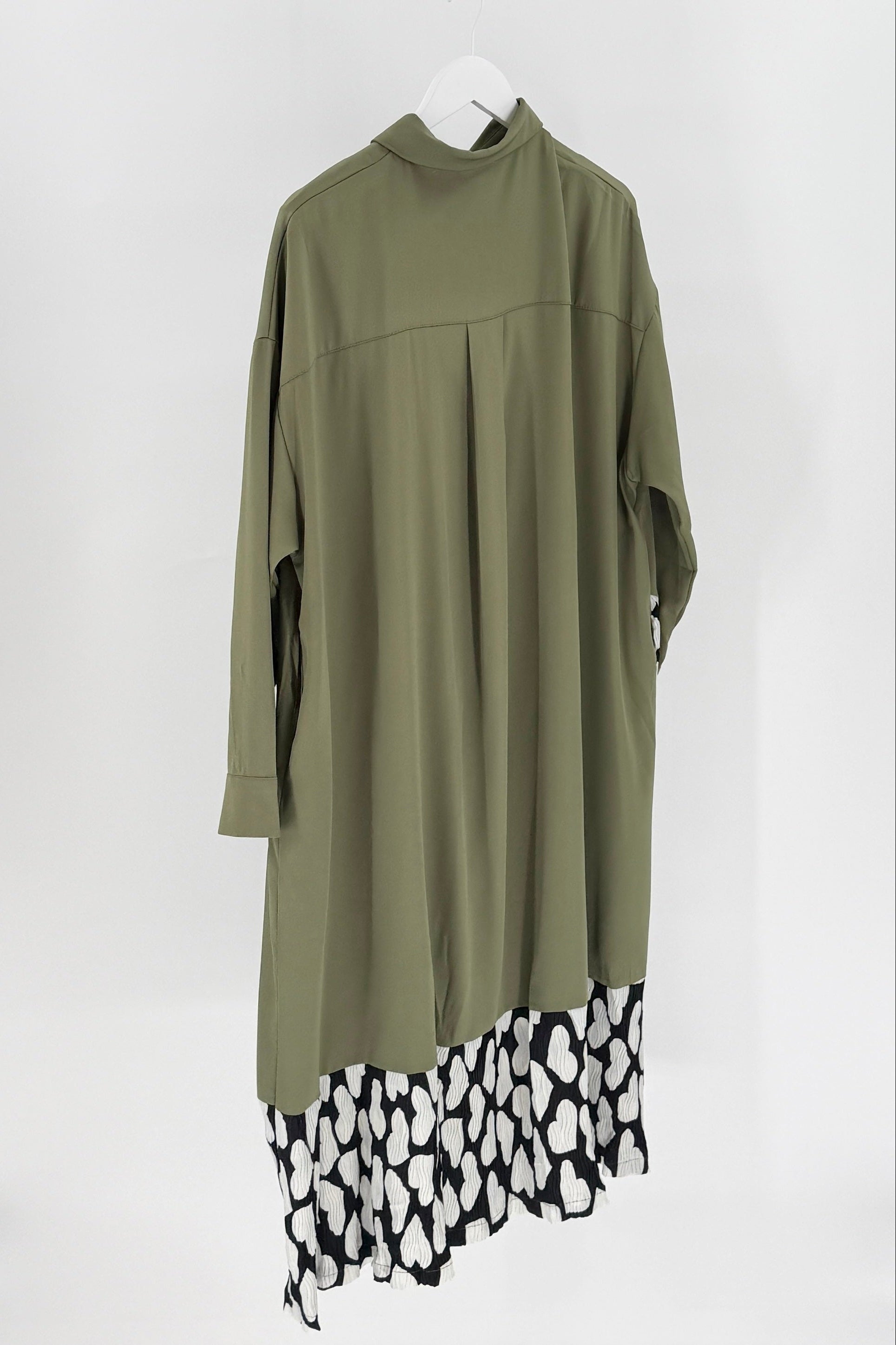 Green dress with leopard print hem on a white background