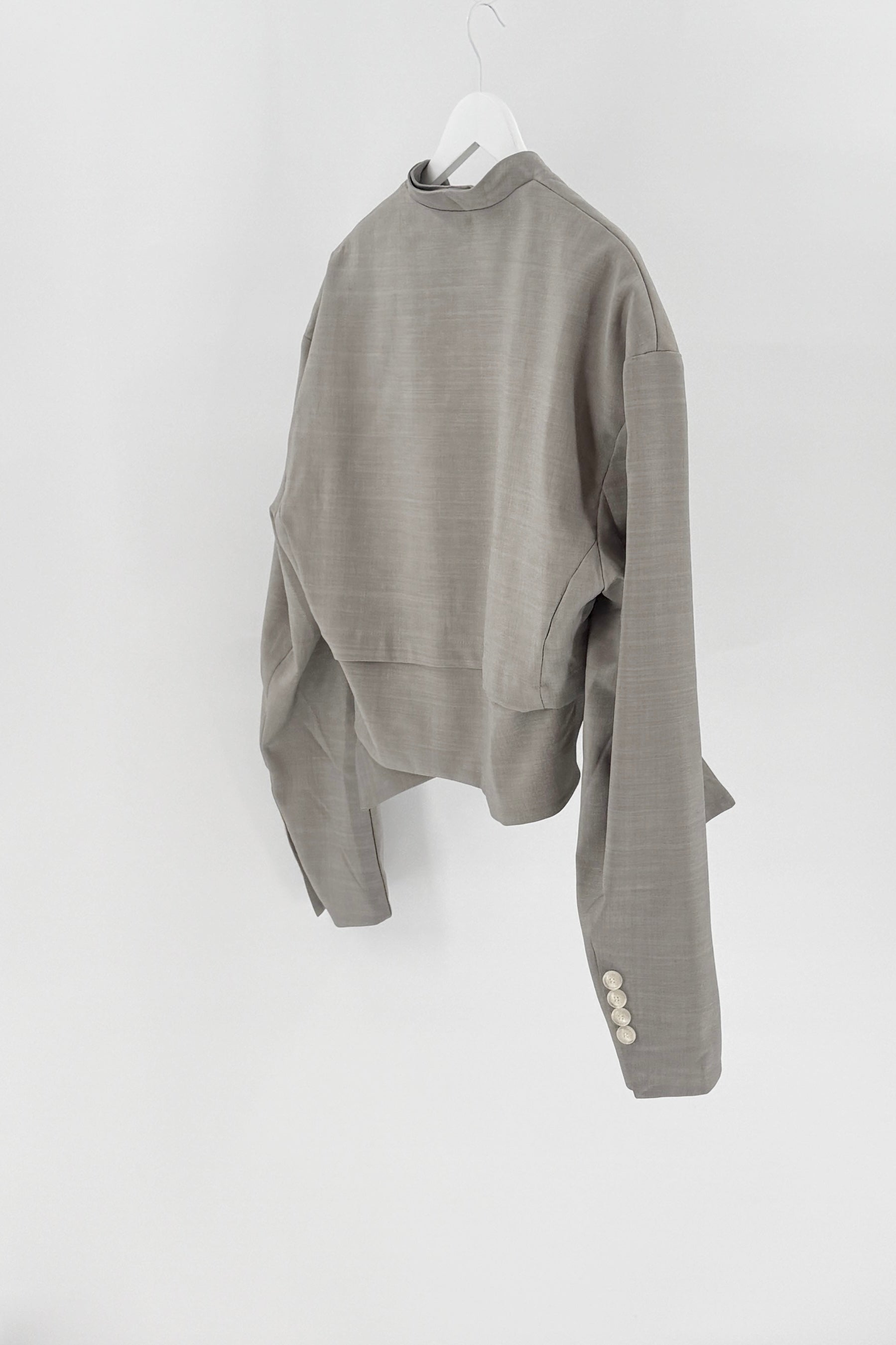 Gray sweater on a hanger against a white background