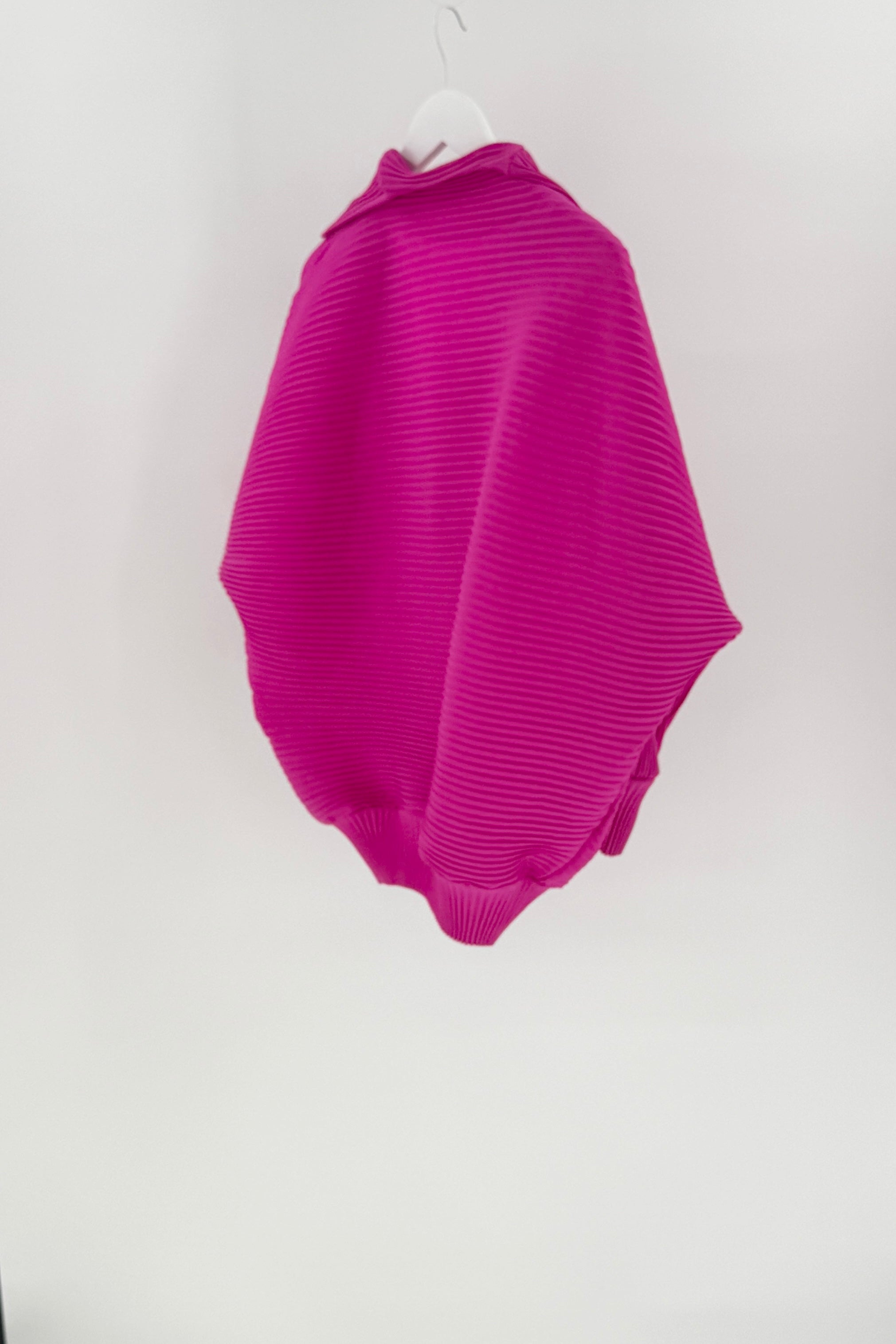 Purple ribbed sweater on a white hanger against a white background