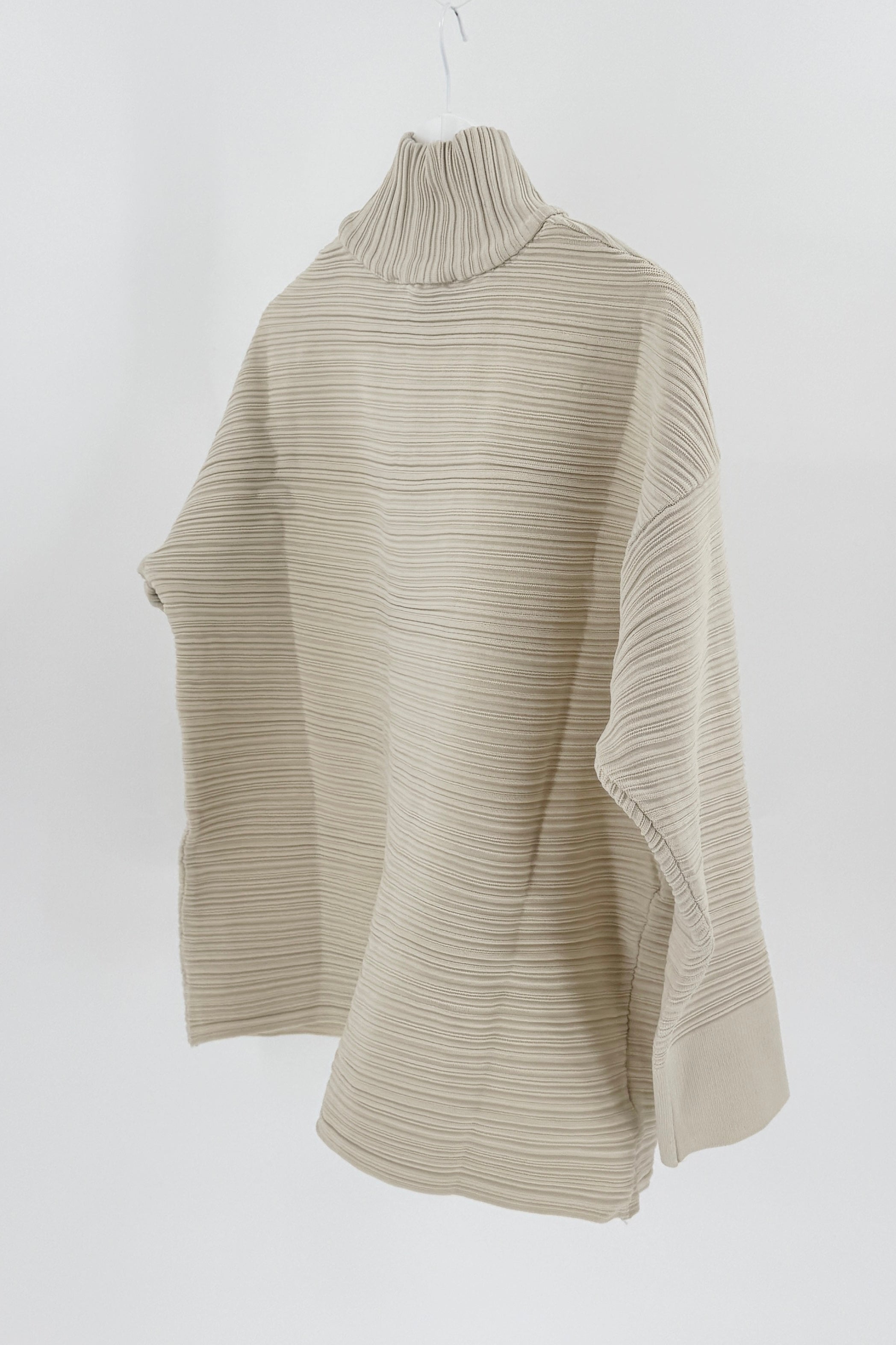Beige ribbed sweater on a white background