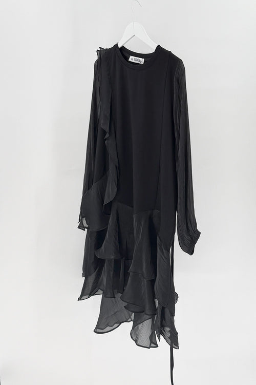 Black dress with sheer overlay on a white hanger against a white background