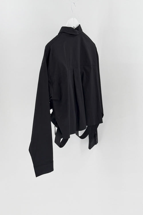 Black top on a white hanger against a white background