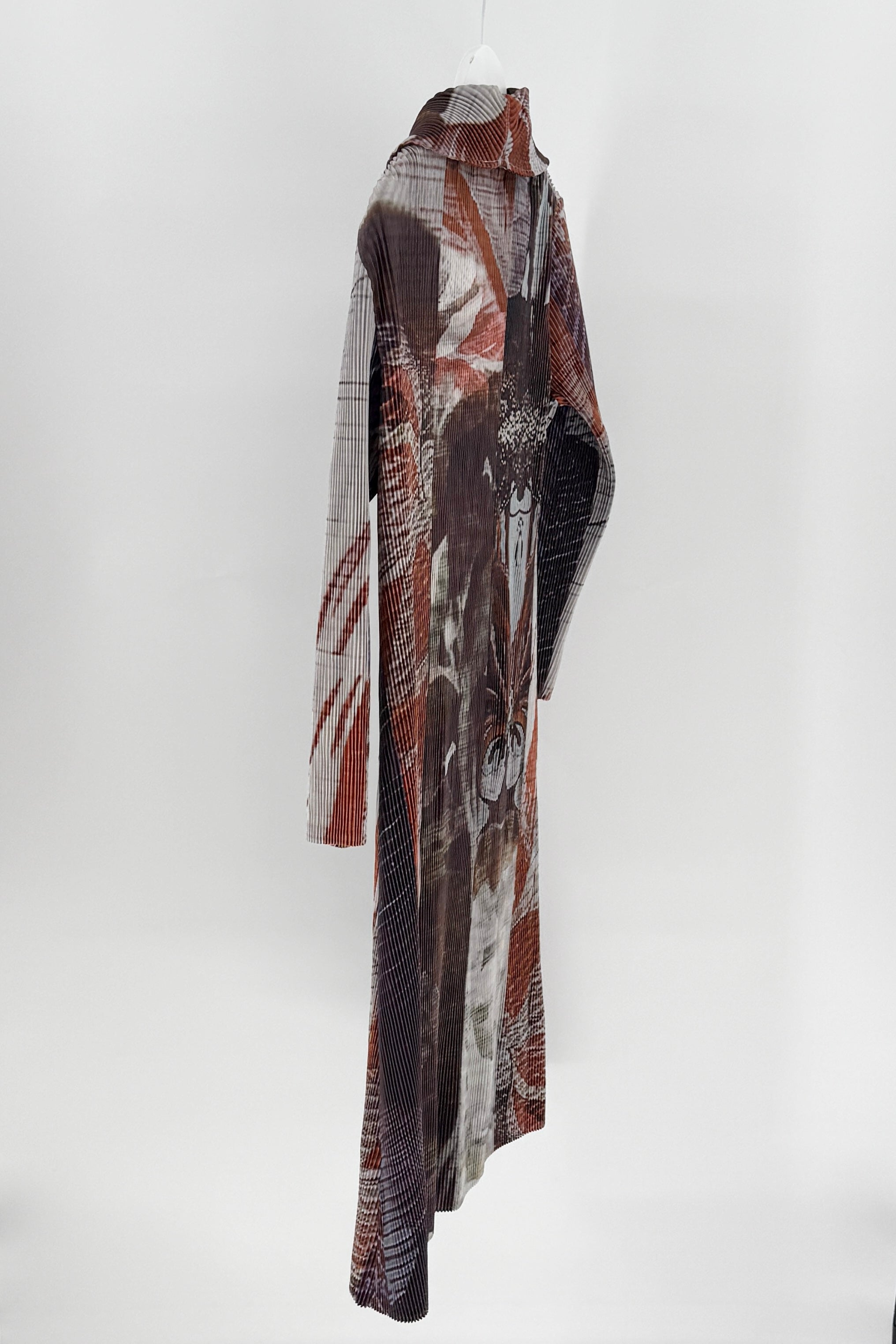 Long, patterned scarf hanging against a white background
