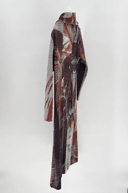 Long, patterned scarf hanging against a white background
