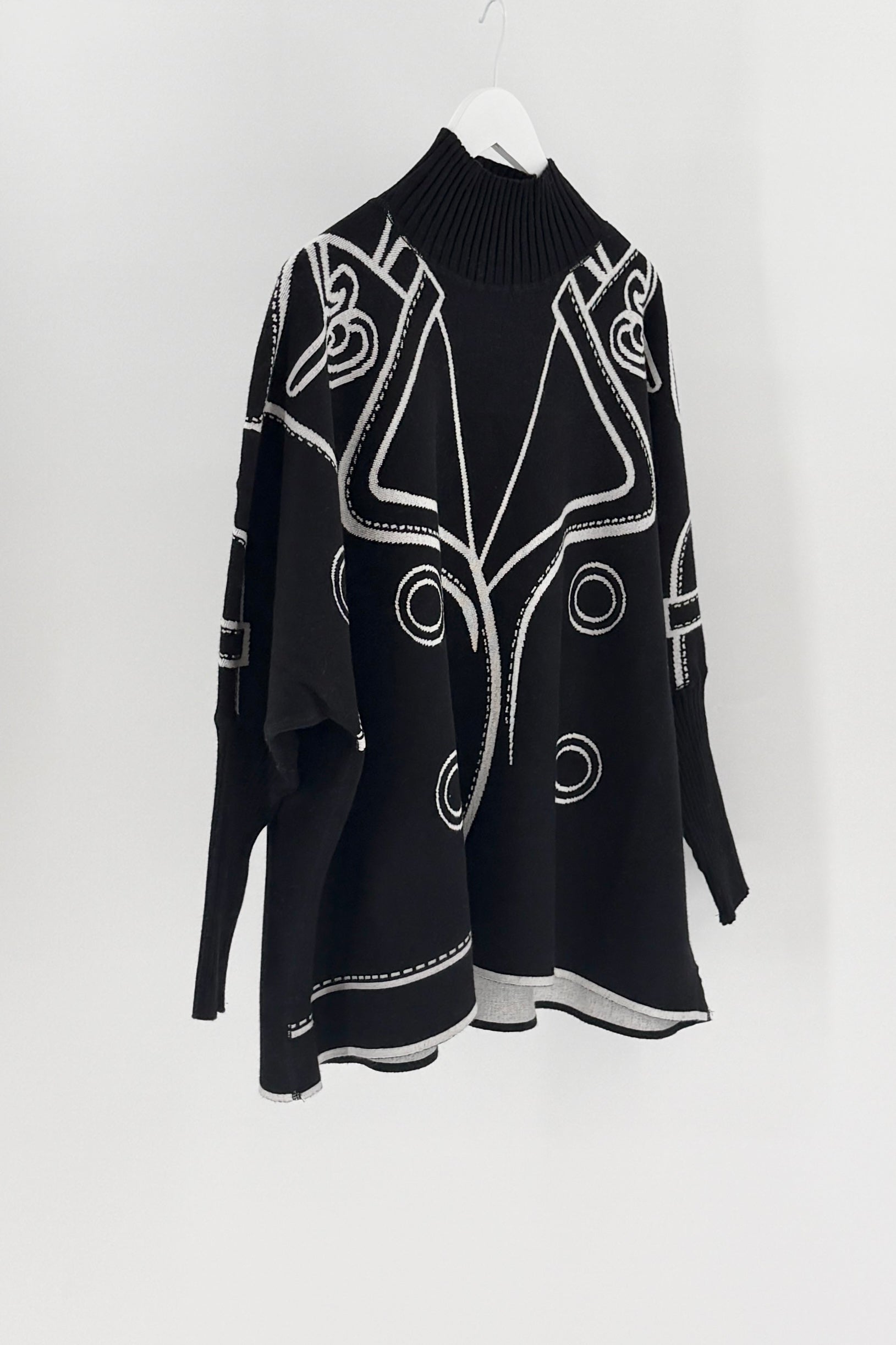 Black sweater with white patterns on a white background