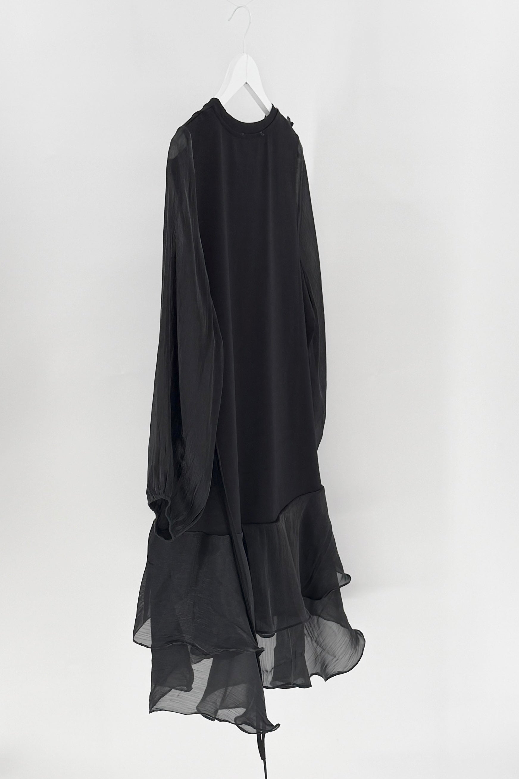 Black long-sleeve dress on a white hanger against a white background