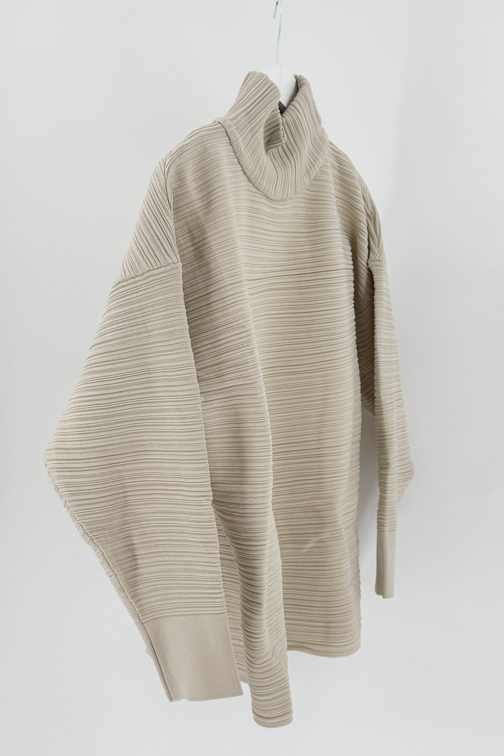 Beige ribbed sweater on a white background