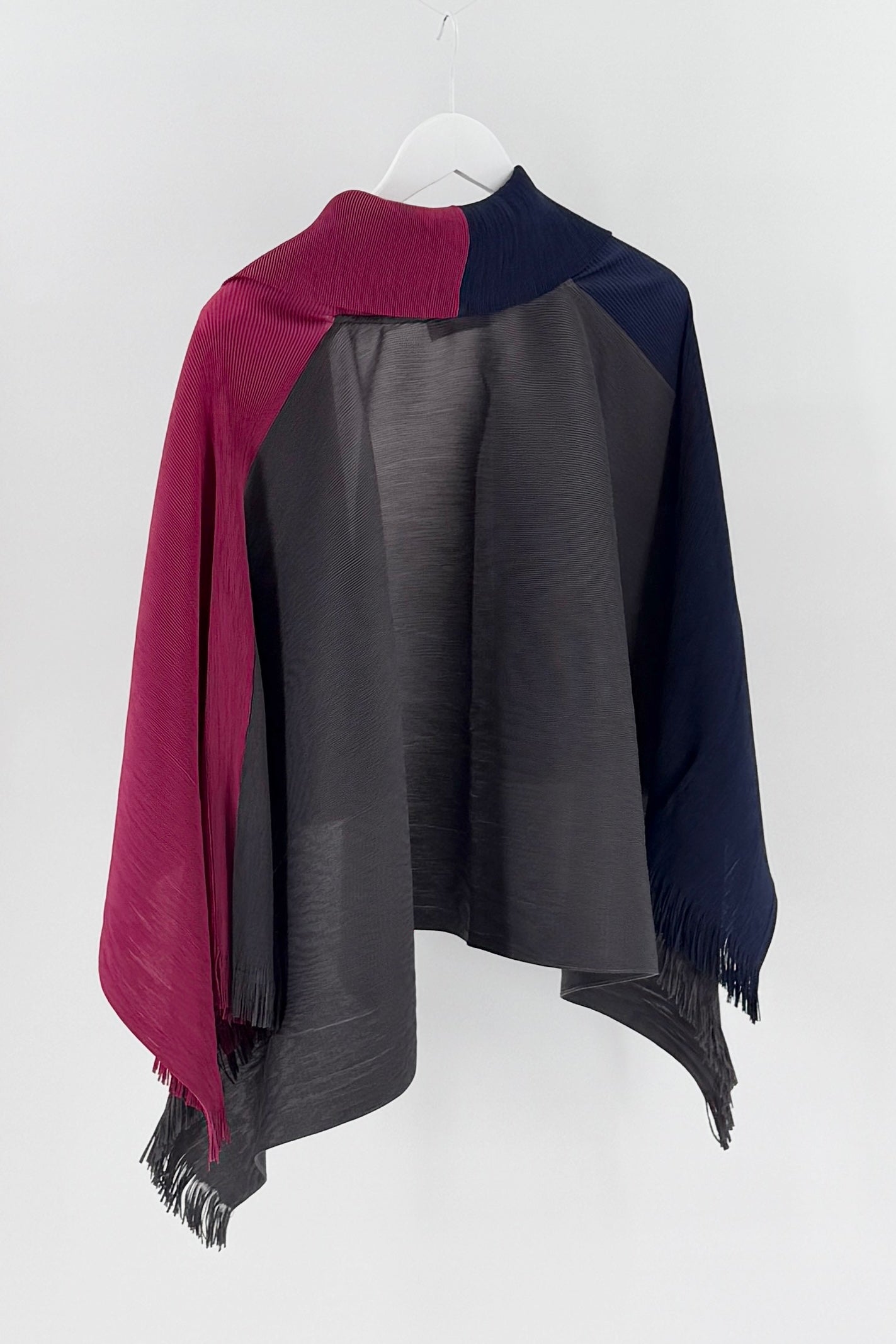 Color-blocked open cardigan with maroon, navy, and gray sections on a white background