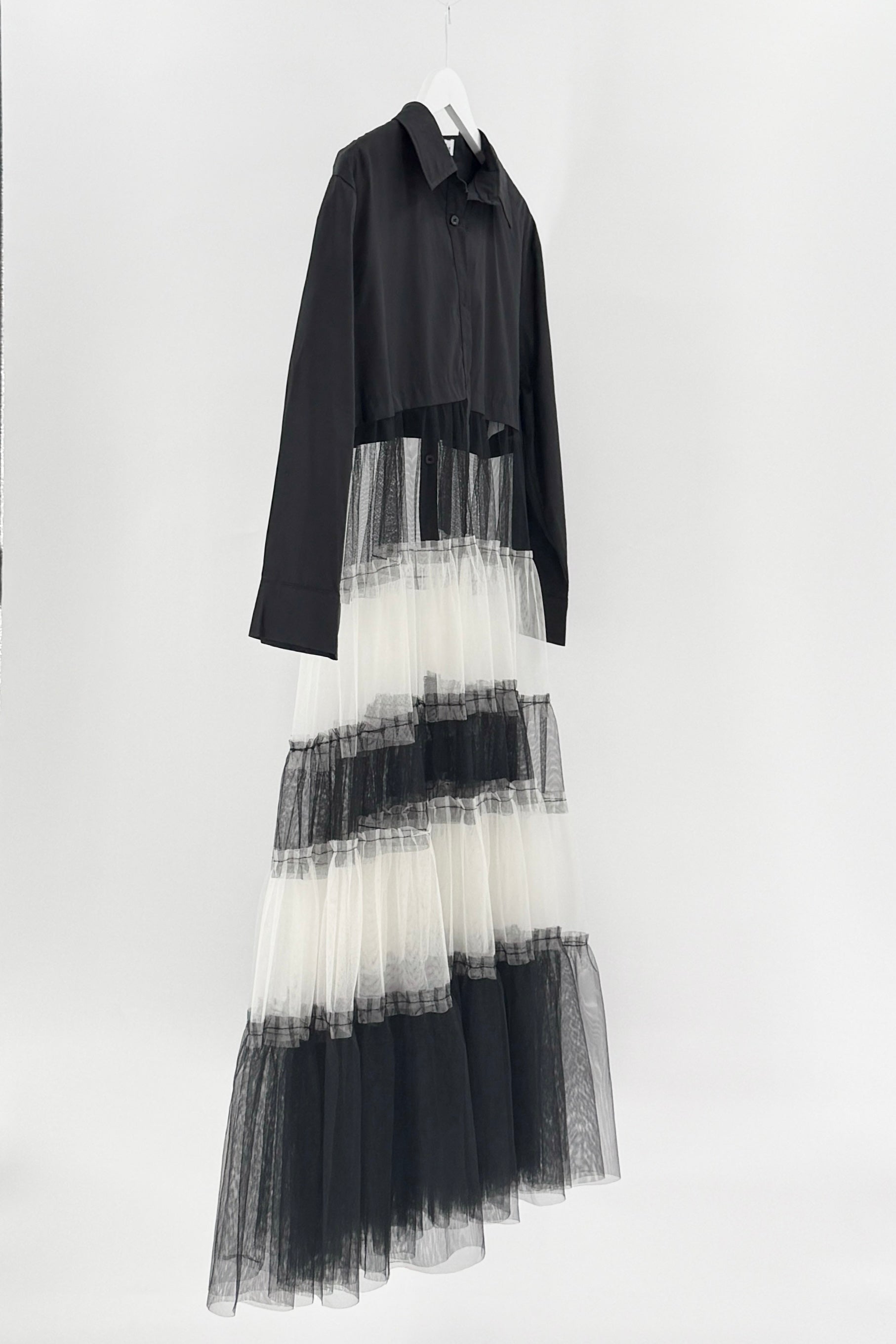 Black and white dress with layered tulle skirt on a white background