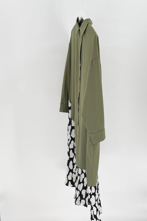 Green coat with a black and white patterned skirt on a white background