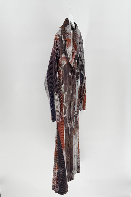 Long, patterned coat hanging on a white background