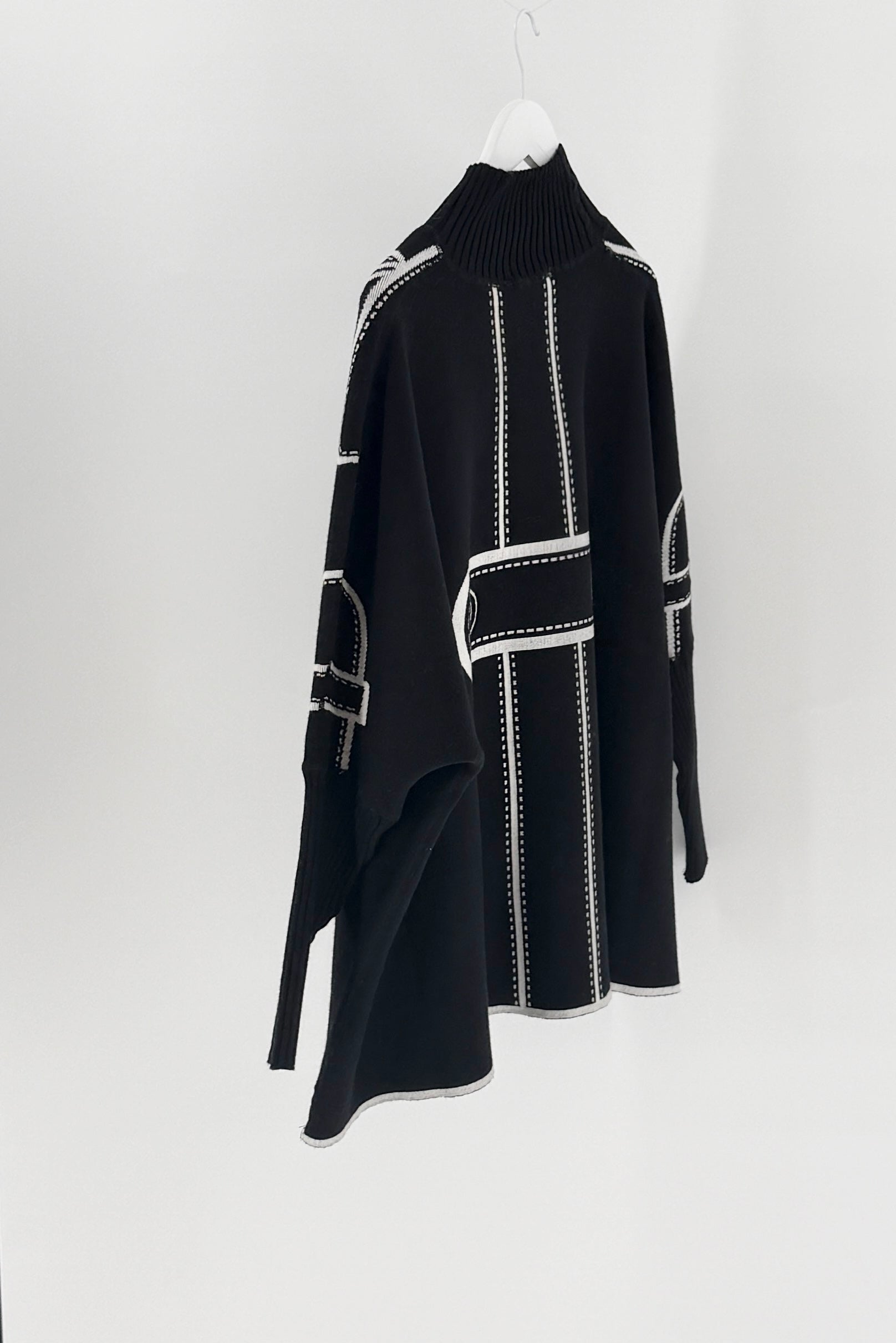 Black dress with white accents on a white background