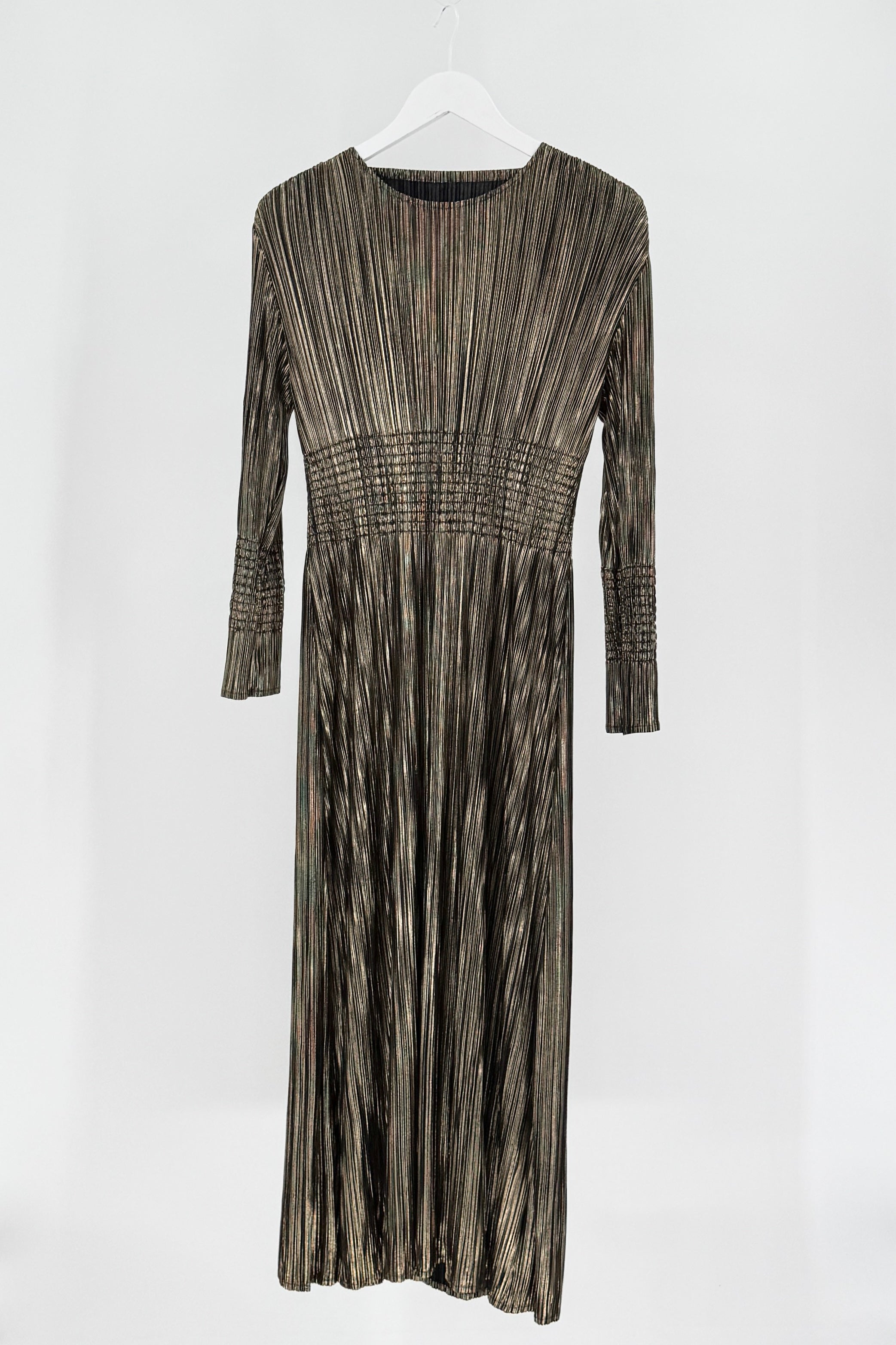 Long-sleeve dress with a pleated pattern on a white background