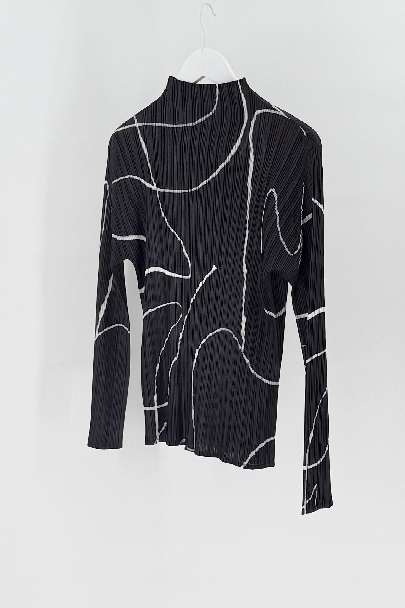 Black ribbed long-sleeve top with white abstract patterns on a white background