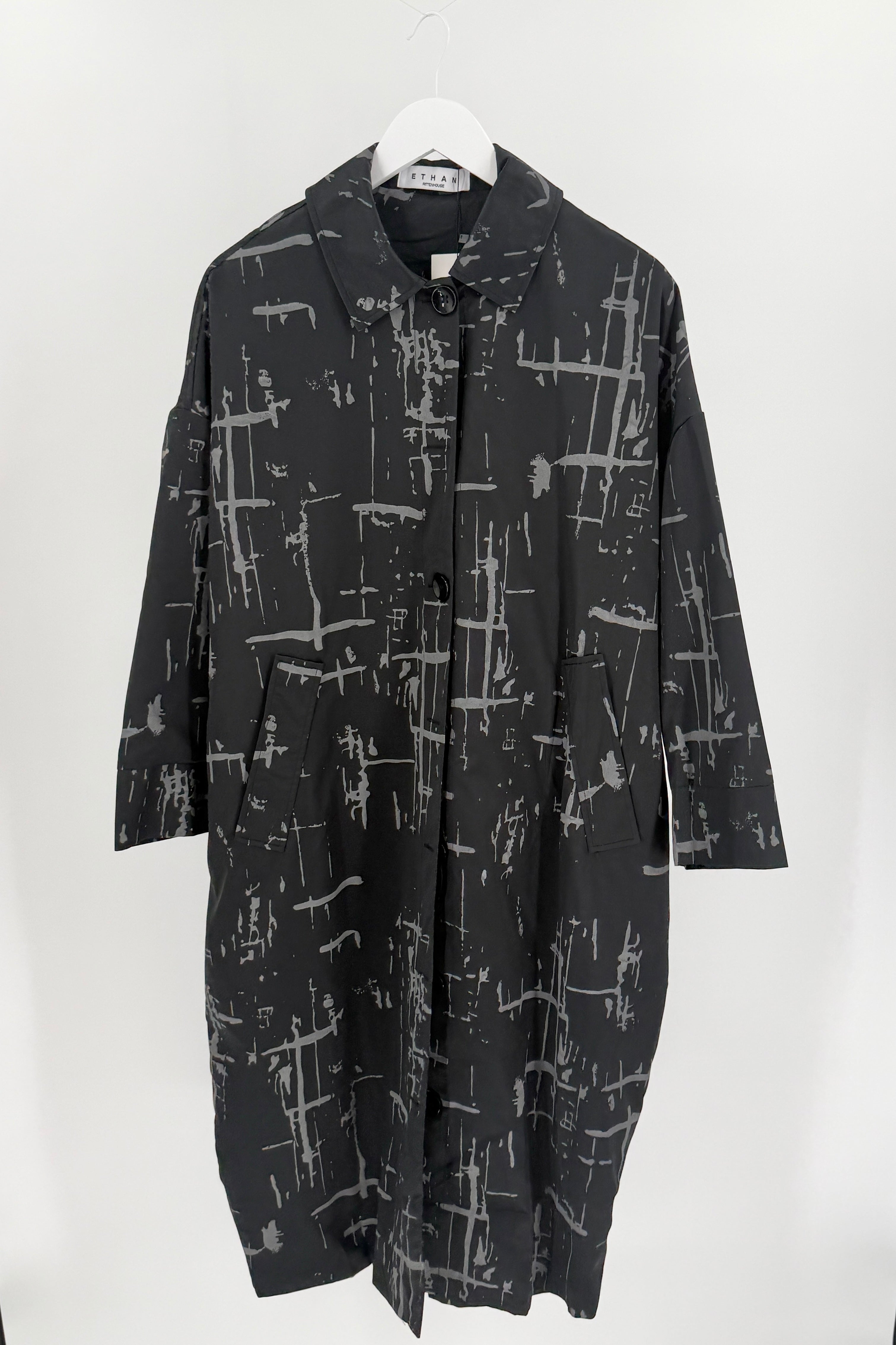 Lightweight black button up dress with a scattered grey horizontal and vertical paint stroke print. 