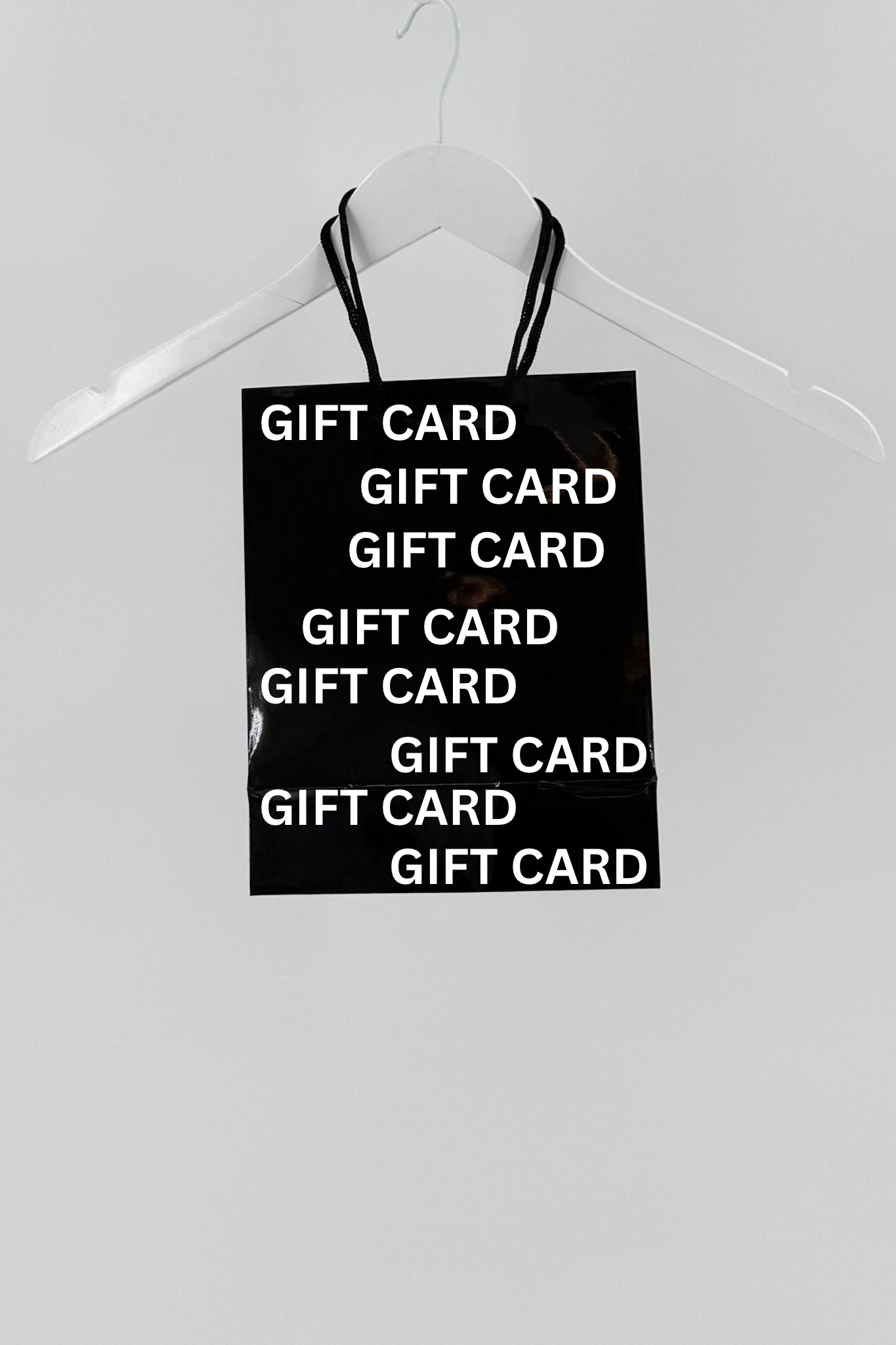 Black sign with 'GIFT CARD' text on a white hanger against a white background